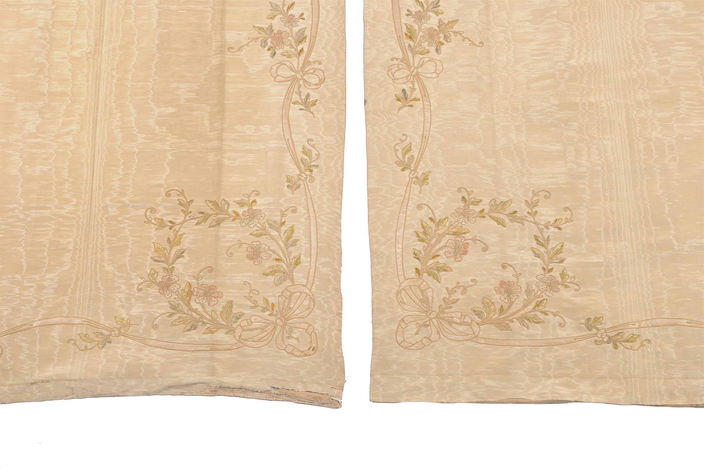 A pair of late 19th/early 20th century moiré silk and floral embroidered panels, possibly entre fenetres, each of pale sand-brown colour, each approximately 291cms high, 120cms wide at the ground (2).